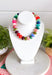 Make a statement with this trendy chunky beaded necklace that's full of color and personality. Featuring bold beads in shades of pink, burgundy, hunter green, green, blue, and black, this eye-catching accessory is accented with dainty colorful pink beads between each larger bead for added texture and charm. Whether you're dressing up a simple sweater or adding the finishing touch to your favorite dress, this necklace brings the perfect pop of playful style to any look.
