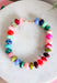 Make a statement with this trendy chunky beaded necklace that's full of color and personality. Featuring bold beads in shades of pink, burgundy, hunter green, green, blue, and black, this eye-catching accessory is accented with dainty colorful pink beads between each larger bead for added texture and charm. Whether you're dressing up a simple sweater or adding the finishing touch to your favorite dress, this necklace brings the perfect pop of playful style to any look.