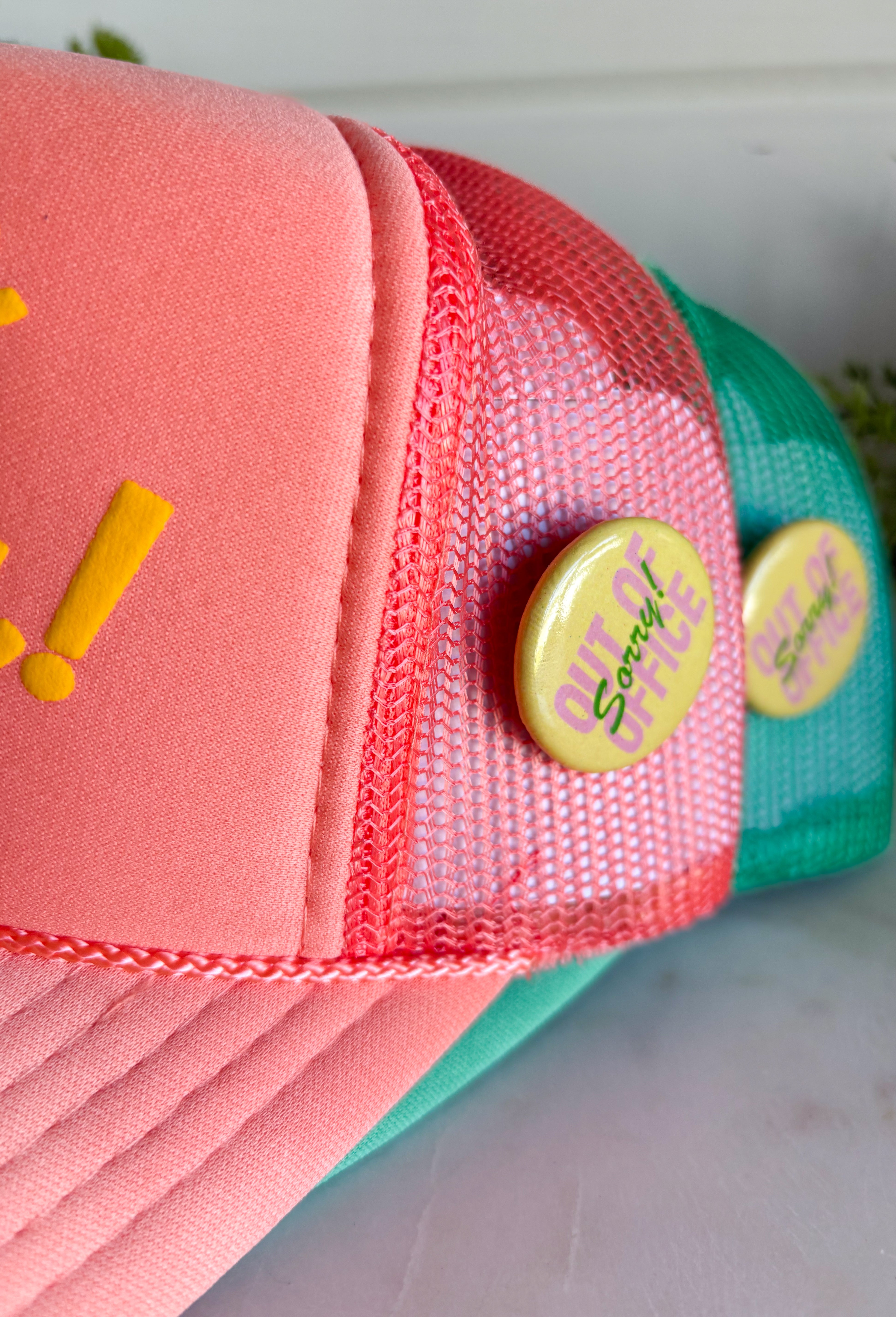 For the girl who’s in no rush and loving it! This coral trucker hat features “Always Lolly-Gagging!” in bright yellow for a fun, carefree statement that doesn’t take life too seriously. Finished with a playful yellow “Sorry Out of Office” button on the side, this hat brings all the laid-back vibes. The breathable mesh backing and adjustable fit make it perfect for sunny days, road trips, and everything in between.