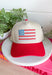 This neutral trucker hat with a red bill is the cutest way to show off your patriotic spirit this summer! The embroidered red, white, and blue floral design creates a unique American flag look that feels both festive and feminine. It’s perfect for the 4th of July, backyard BBQs, lake days, and all your sunny celebrations. With a adjustable fit, it’s as comfortable as it is eye-catching. 