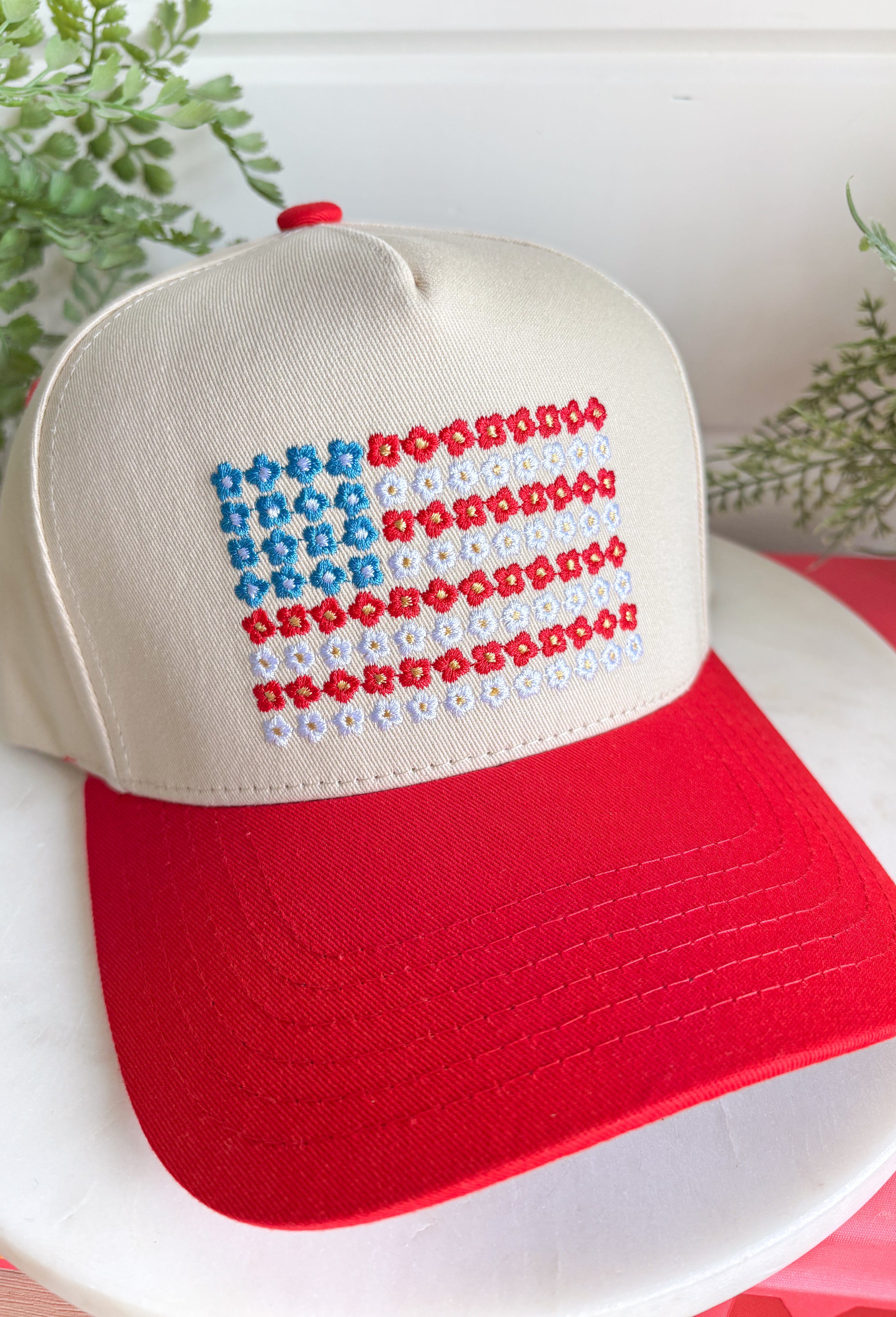 This neutral trucker hat with a red bill is the cutest way to show off your patriotic spirit this summer! The embroidered red, white, and blue floral design creates a unique American flag look that feels both festive and feminine. It’s perfect for the 4th of July, backyard BBQs, lake days, and all your sunny celebrations. With a adjustable fit, it’s as comfortable as it is eye-catching. 