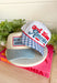 This white trucker hat with a blue gingham bill is the sweetest patriotic touch for your summer lineup! The embroidered “God Bless America” in red and blue adds a festive pop, while the gingham detail keeps it feeling fresh and fun. Perfect for the 4th of July, lake days, or backyard BBQs, this hat is both cute and practical with its breathable design and adjustable fit. It’s an easy way to pull your whole look together while staying cool in the sun. 