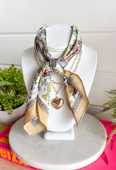This neck scarf necklace set is the ultimate trendy, throw-on-and-go accessory for summer! Featuring a neutral abstract print scarf paired with a gold textured heart necklace and a dainty gold chain, it gives you that perfectly layered look with zero effort. It’s such a fun way to elevate even your simplest outfits—just add it to a tank or dress and you’re instantly styled. Lightweight and easy to wear, this piece brings a mix of chic and playful that feels so current. 