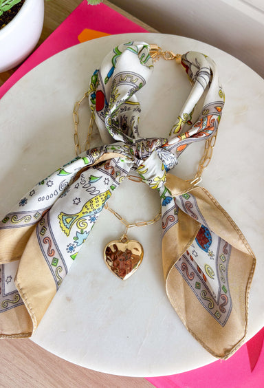 This neck scarf necklace set is the ultimate trendy, throw-on-and-go accessory for summer! Featuring a neutral abstract print scarf paired with a gold textured heart necklace and a dainty gold chain, it gives you that perfectly layered look with zero effort. It’s such a fun way to elevate even your simplest outfits—just add it to a tank or dress and you’re instantly styled. Lightweight and easy to wear, this piece brings a mix of chic and playful that feels so current. 