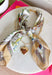 This neck scarf necklace set is the ultimate trendy, throw-on-and-go accessory for summer! Featuring a neutral abstract print scarf paired with a gold textured heart necklace and a dainty gold chain, it gives you that perfectly layered look with zero effort. It’s such a fun way to elevate even your simplest outfits—just add it to a tank or dress and you’re instantly styled. Lightweight and easy to wear, this piece brings a mix of chic and playful that feels so current. 