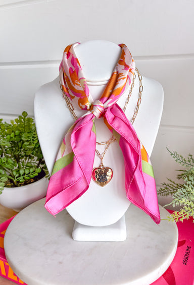 This neck scarf necklace set is the ultimate trendy, throw-on-and-go accessory for summer! Featuring a colorful abstract print scarf paired with a gold textured heart necklace and a dainty gold chain, it gives you that perfectly layered look with zero effort. It’s such a fun way to elevate even your simplest outfits—just add it to a tank or dress and you’re instantly styled. Lightweight and easy to wear, this piece brings a mix of chic and playful that feels so current. 