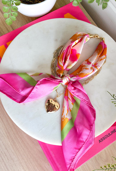 This neck scarf necklace set is the ultimate trendy, throw-on-and-go accessory for summer! Featuring a colorful abstract print scarf paired with a gold textured heart necklace and a dainty gold chain, it gives you that perfectly layered look with zero effort. It’s such a fun way to elevate even your simplest outfits—just add it to a tank or dress and you’re instantly styled. Lightweight and easy to wear, this piece brings a mix of chic and playful that feels so current. 