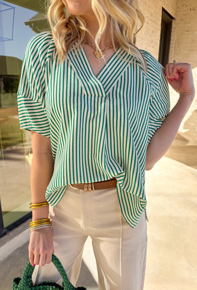 Simple, fresh, and perfect for spring styling, this green and white striped short sleeve top by Entro is an easy everyday favorite. The classic stripe pattern feels crisp and seasonal, while the v-neckline adds a flattering, effortless touch. Lightweight and easy to wear, this top pairs perfectly with denim, shorts, or a flowy skirt for a clean spring look.