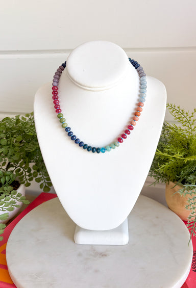Complete your fall look with a necklace that captures the colors of the season! Featuring beautiful beads in rich shades of navy, purple, green, and brown, this timeless accessory adds the perfect finishing touch to everything from cozy sweaters to feminine blouses. Whether you're dressing up for dinner or adding a little extra charm to your everyday outfit, this versatile necklace is one you'll reach for all season long.