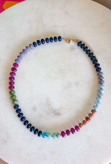 Complete your fall look with a necklace that captures the colors of the season! Featuring beautiful beads in rich shades of navy, purple, green, and brown, this timeless accessory adds the perfect finishing touch to everything from cozy sweaters to feminine blouses. Whether you're dressing up for dinner or adding a little extra charm to your everyday outfit, this versatile necklace is one you'll reach for all season long.