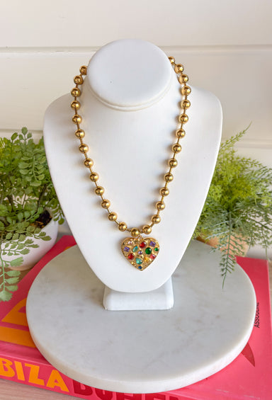 Secure your style with the Confetti Heart Necklace. This unique necklace features a gold heart pendant with jewel toned gems on a fun bubble chain for a unique and trendy look. Layers well with others or wear it on it's own!