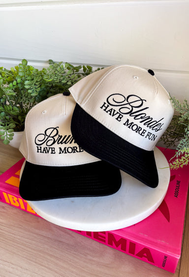 This trucker hat is bringing the attitude—in the best way! Featuring “Blondes Have More Fun” embroidered across the front, it’s the perfect mix of playful and a little bold. The tan base with a black bill keeps it easy to style, while the statement graphic does all the talking. Whether you're heading out for errands, a casual day with friends, or just embracing your blonde era, this hat adds that fun finishing touch. 