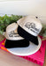 This trucker hat is bringing the attitude—in the best way! Featuring “Blondes Have More Fun” embroidered across the front, it’s the perfect mix of playful and a little bold. The tan base with a black bill keeps it easy to style, while the statement graphic does all the talking. Whether you're heading out for errands, a casual day with friends, or just embracing your blonde era, this hat adds that fun finishing touch. 