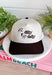 For anyone who considers taking their sweet time a personality trait, this “Born To Dilly Dally” trucker hat from The Happiest gets it. The neutral design is finished with a chocolate brown bill and matching embroidered lettering for an easy, everyday color combo. The real star is the embroidered duck wearing a scarf and sunglasses—because apparently even the ducks have mastered the art of having nowhere important to be.