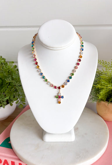 Add a meaningful touch of color to your jewelry collection with this beautiful cross necklace. Featuring a strand of colorful rhinestone crystals in shades of red, blue, green, pink, and gold, this eye-catching piece is finished with a matching cross pendant for the perfect blend of faith and style. The vibrant colors and delicate gold accents make it a standout accessory that's easy to wear for both everyday outfits and special occasions.