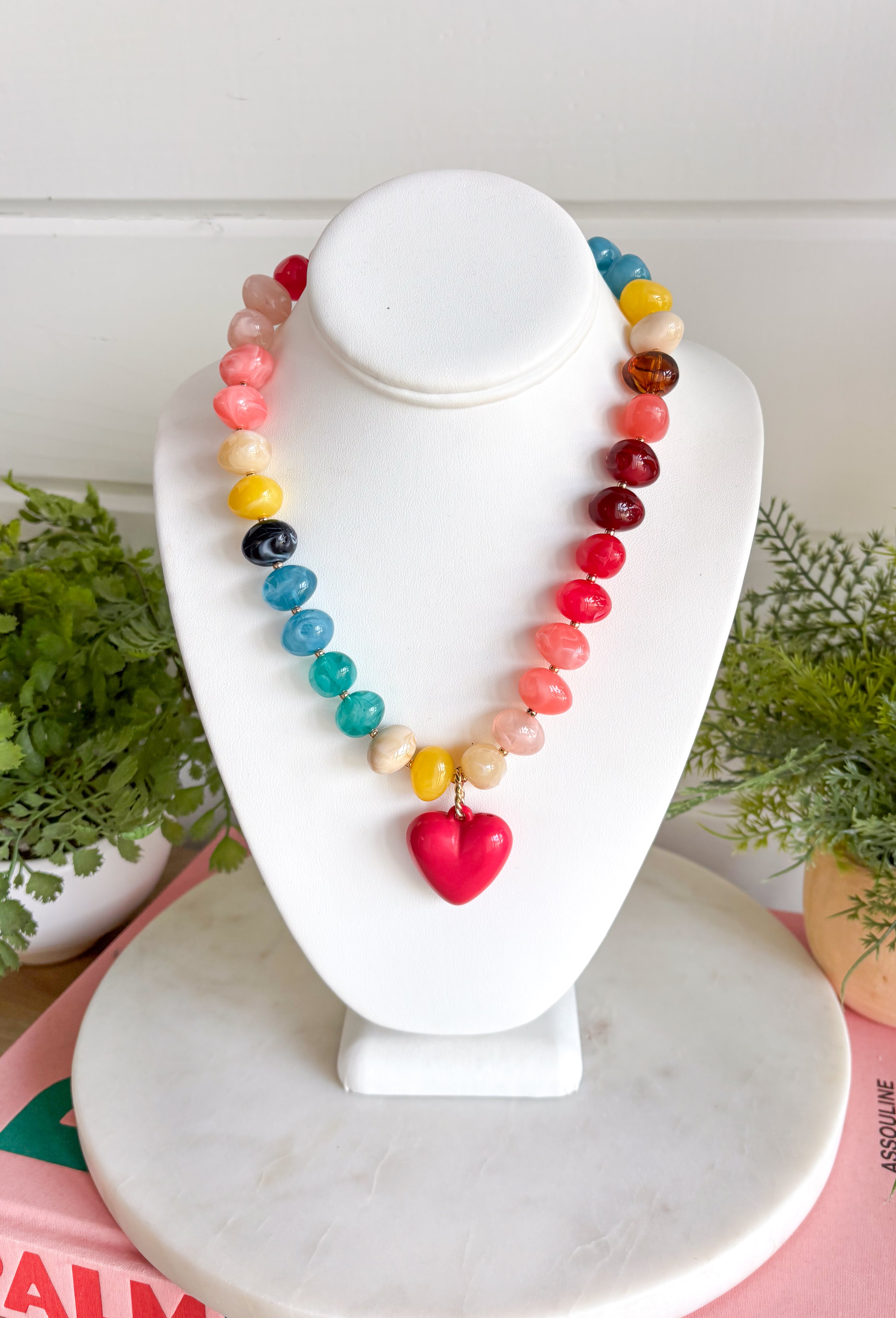 A little color and a lot of heart make this beaded necklace such a fun addition to your jewelry collection. Colorful beads in blue, yellow, burgundy, and pink create a playful mix, while the pink heart charm pendant adds an extra-sweet focal point. Finished with 18K gold-dipped details, it has just the right touch of shine to bring the whole look together. Wear it solo for a cheerful pop of color or layer it with your favorite gold necklaces for a fun, collected look.
