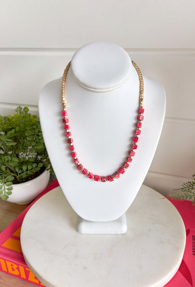 This matte gold and pink beaded necklace is the perfect little pop of color your summer outfits have been waiting for! The mix of square matte gold beads and pink accents gives it a fun, trendy feel while still being easy to style every day. Lightweight and eye-catching, it layers beautifully or stands out on its own with your favorite tanks and dresses. 