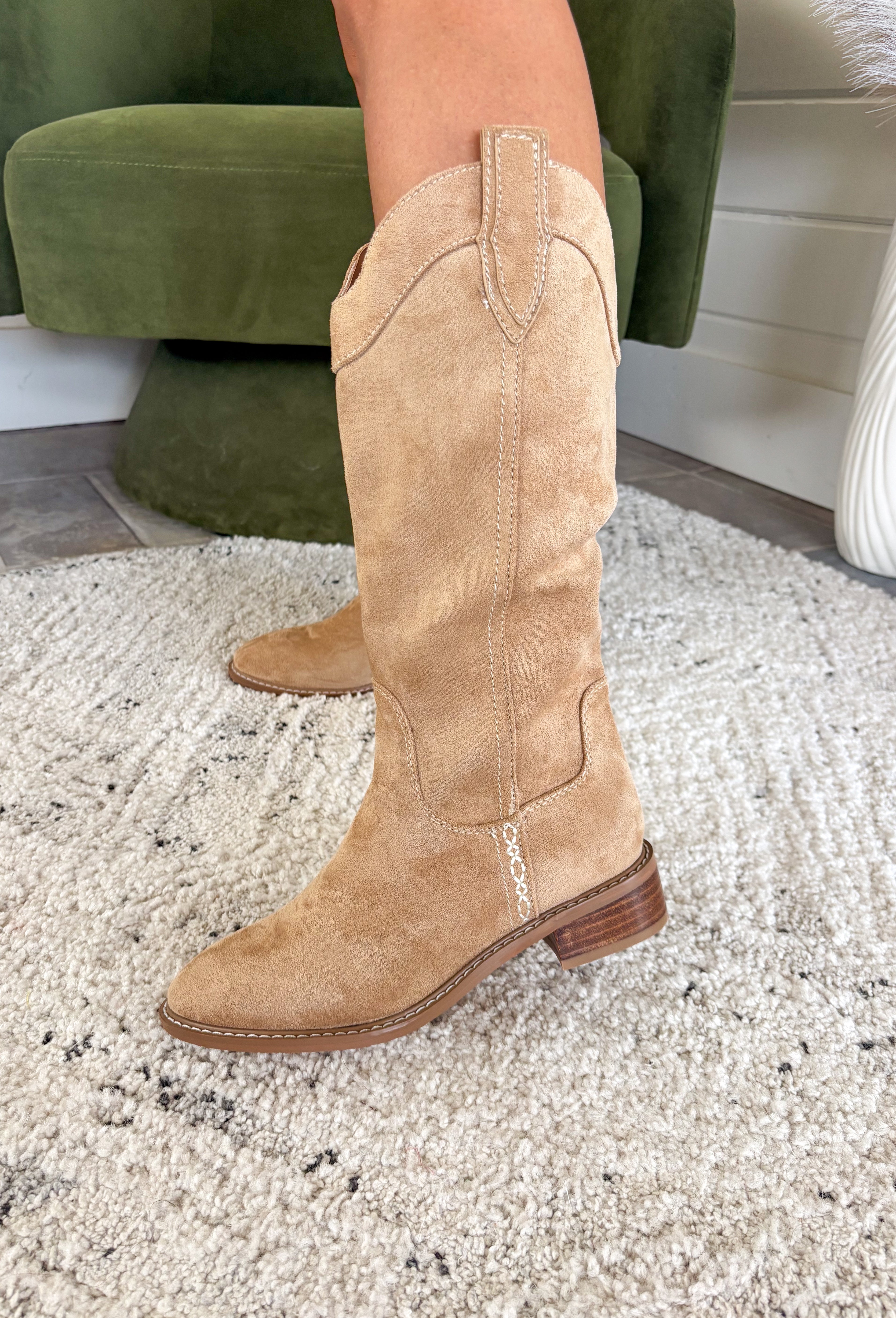 Step out in timeless Western style with the Merida Boot by Chinese Laundry. A fresh take on the classic cowgirl silhouette, this boot blends sleek lines with everyday comfort. Featuring a pointed toe, pull-on design, and a chic finish, it’s the perfect blend of rugged charm and modern flair. Whether you’re pairing it with denim, dresses, or cozy winter layers, the Merida is your new go-to boot for the season.