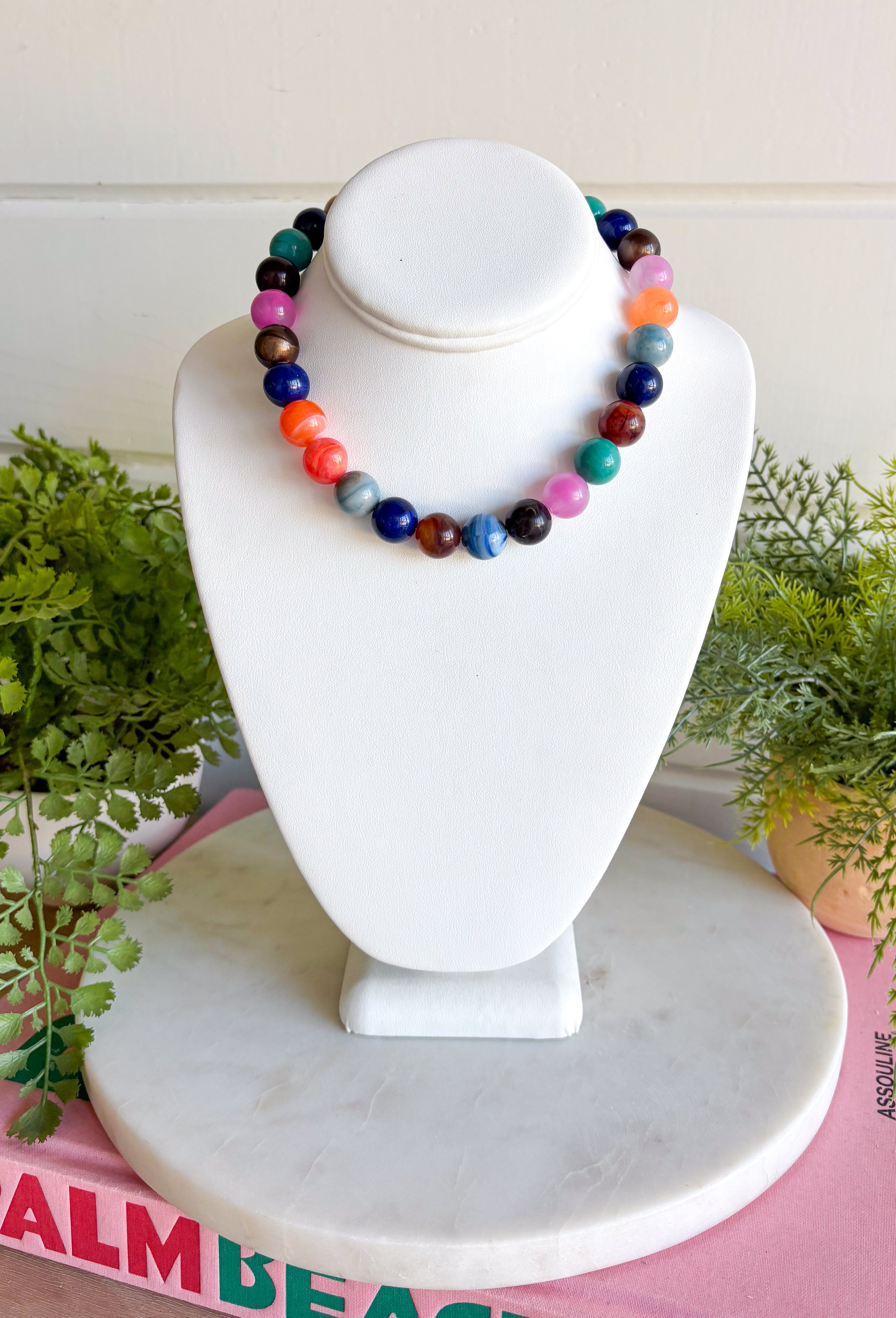 A playful mix of rich color makes this beaded necklace from Adore an easy way to brighten up your everyday jewelry. Beads in shades of teal, navy, coral, brown, black, and pink come together for a colorful combination that feels bold while still being easy to style. The mix of deeper tones and brighter pops gives it plenty of personality whether you’re wearing it with a cozy neutral sweater or a simple blouse. 
