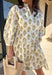Fresh, feminine, and effortlessly flattering, this off-white long sleeve dress is made for spring days ahead. Featuring a green and pink floral print throughout, it feels light, cheerful, and easy to wear. The button-down front and front pocket add a classic touch, while smocking at the waist creates a comfortable, flattering fit that still feels relaxed. Fully lined and crafted from breathable cotton, this dress is perfect for brunch, showers, or any day you want to feel put together without trying too har