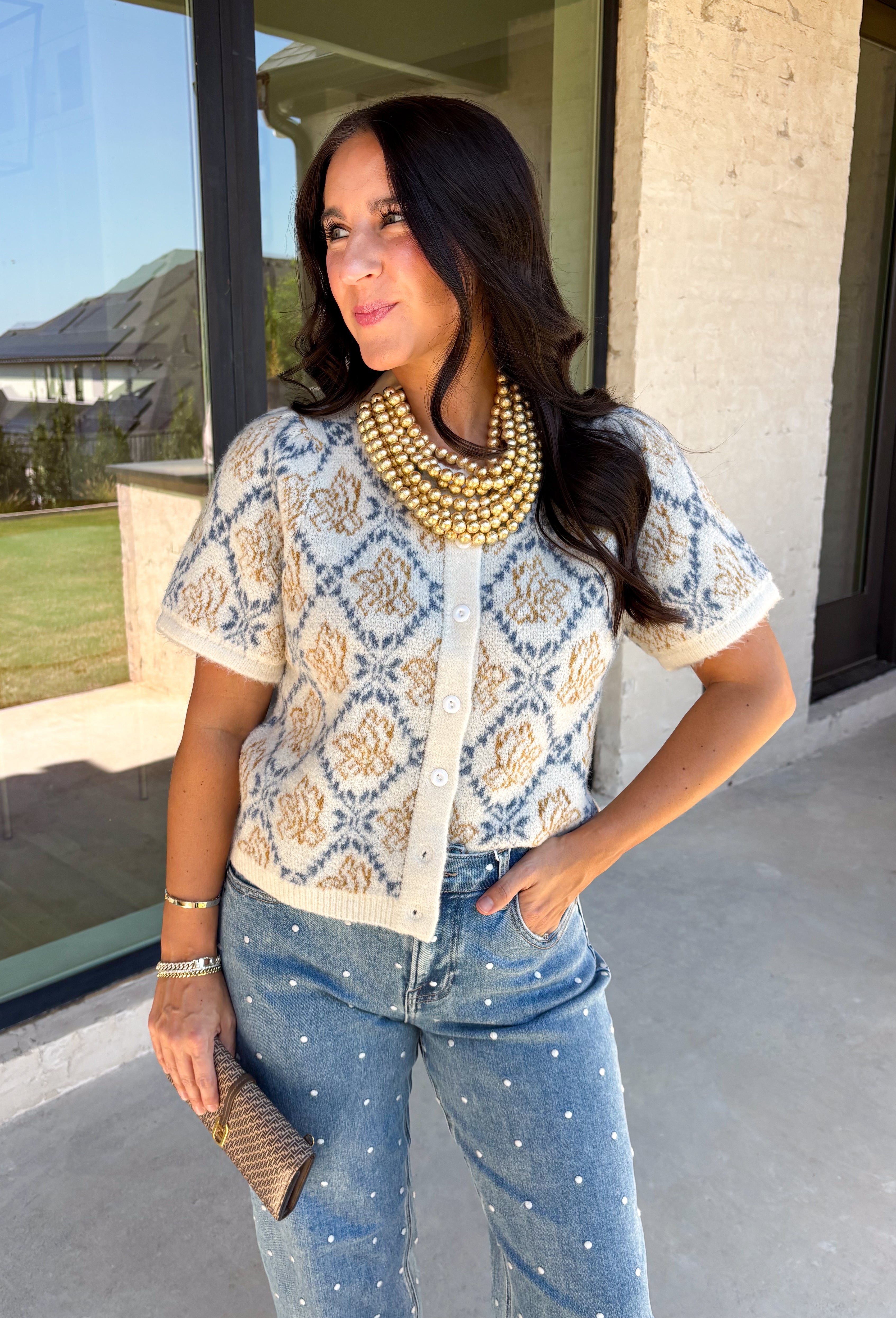 Give your fall layers a vintage-inspired update with this soft short sleeve cardigan from & Merci. The mix of muted denim blue, warm camel, and ivory creates a cozy, lived-in color palette that feels right at home with your favorite autumn outfits. A button-down front makes it easy to wear closed as a top or open over a simple tank for a layered look. Soft and comfortable with just the right amount of stretch, this printed cardigan is an easy statement piece.