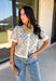 Give your fall layers a vintage-inspired update with this soft short sleeve cardigan from & Merci. The mix of muted denim blue, warm camel, and ivory creates a cozy, lived-in color palette that feels right at home with your favorite autumn outfits. A button-down front makes it easy to wear closed as a top or open over a simple tank for a layered look. Soft and comfortable with just the right amount of stretch, this printed cardigan is an easy statement piece.