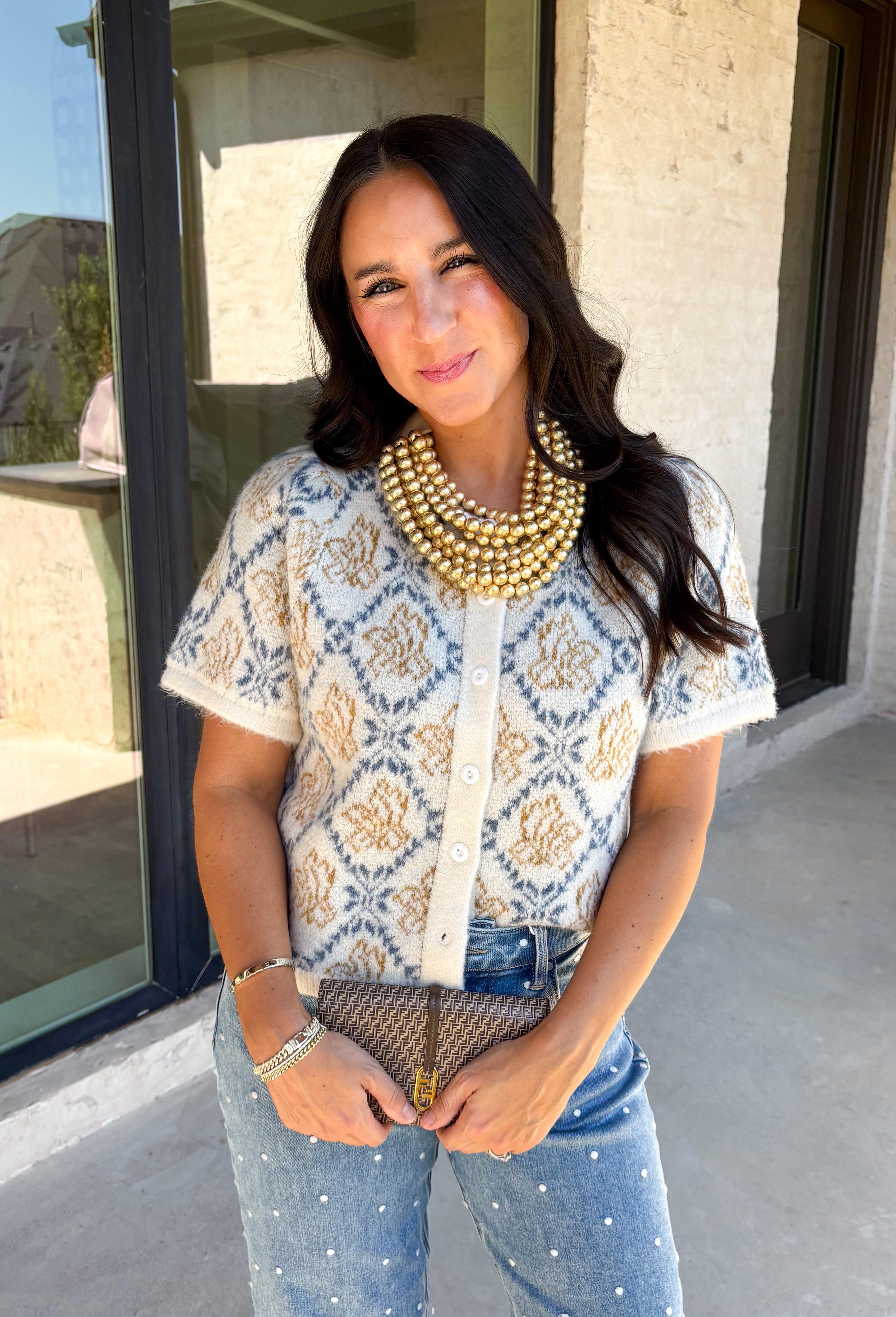 Give your fall layers a vintage-inspired update with this soft short sleeve cardigan from & Merci. The mix of muted denim blue, warm camel, and ivory creates a cozy, lived-in color palette that feels right at home with your favorite autumn outfits. A button-down front makes it easy to wear closed as a top or open over a simple tank for a layered look. Soft and comfortable with just the right amount of stretch, this printed cardigan is an easy statement piece.