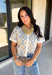 Give your fall layers a vintage-inspired update with this soft short sleeve cardigan from & Merci. The mix of muted denim blue, warm camel, and ivory creates a cozy, lived-in color palette that feels right at home with your favorite autumn outfits. A button-down front makes it easy to wear closed as a top or open over a simple tank for a layered look. Soft and comfortable with just the right amount of stretch, this printed cardigan is an easy statement piece.