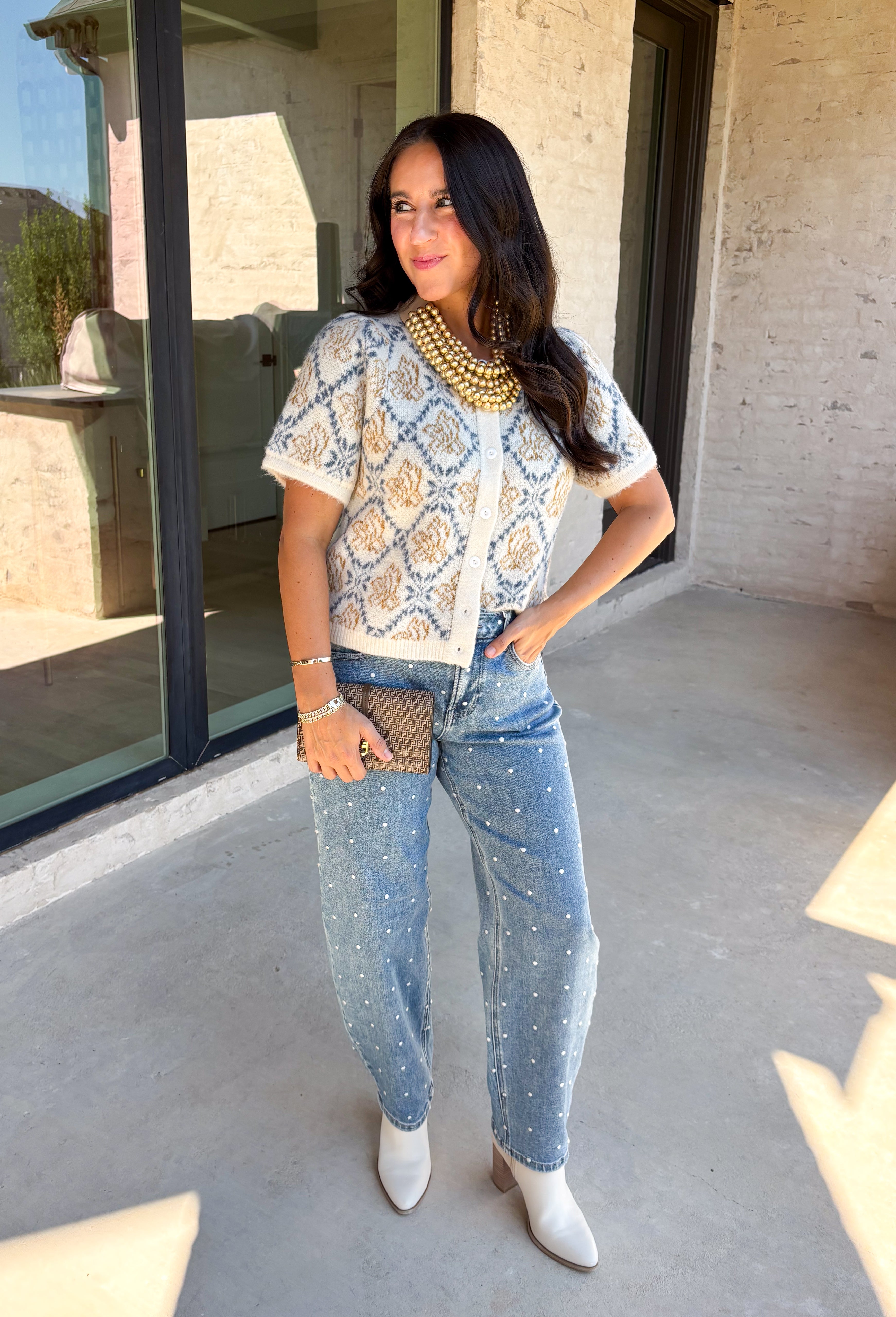 Give your fall layers a vintage-inspired update with this soft short sleeve cardigan from & Merci. The mix of muted denim blue, warm camel, and ivory creates a cozy, lived-in color palette that feels right at home with your favorite autumn outfits. A button-down front makes it easy to wear closed as a top or open over a simple tank for a layered look. Soft and comfortable with just the right amount of stretch, this printed cardigan is an easy statement piece.