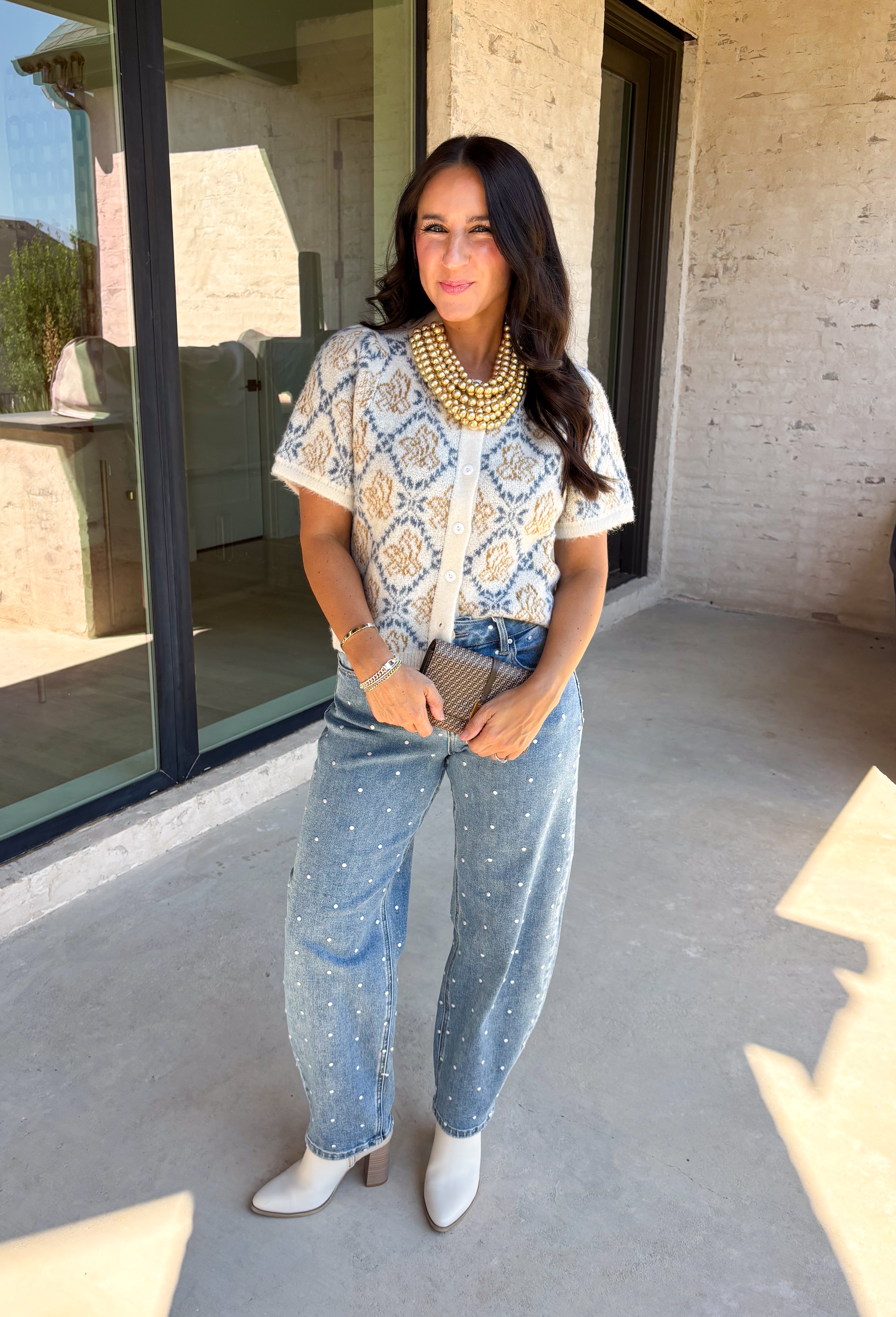 Give your fall layers a vintage-inspired update with this soft short sleeve cardigan from & Merci. The mix of muted denim blue, warm camel, and ivory creates a cozy, lived-in color palette that feels right at home with your favorite autumn outfits. A button-down front makes it easy to wear closed as a top or open over a simple tank for a layered look. Soft and comfortable with just the right amount of stretch, this printed cardigan is an easy statement piece.