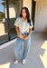 Give your fall layers a vintage-inspired update with this soft short sleeve cardigan from & Merci. The mix of muted denim blue, warm camel, and ivory creates a cozy, lived-in color palette that feels right at home with your favorite autumn outfits. A button-down front makes it easy to wear closed as a top or open over a simple tank for a layered look. Soft and comfortable with just the right amount of stretch, this printed cardigan is an easy statement piece.