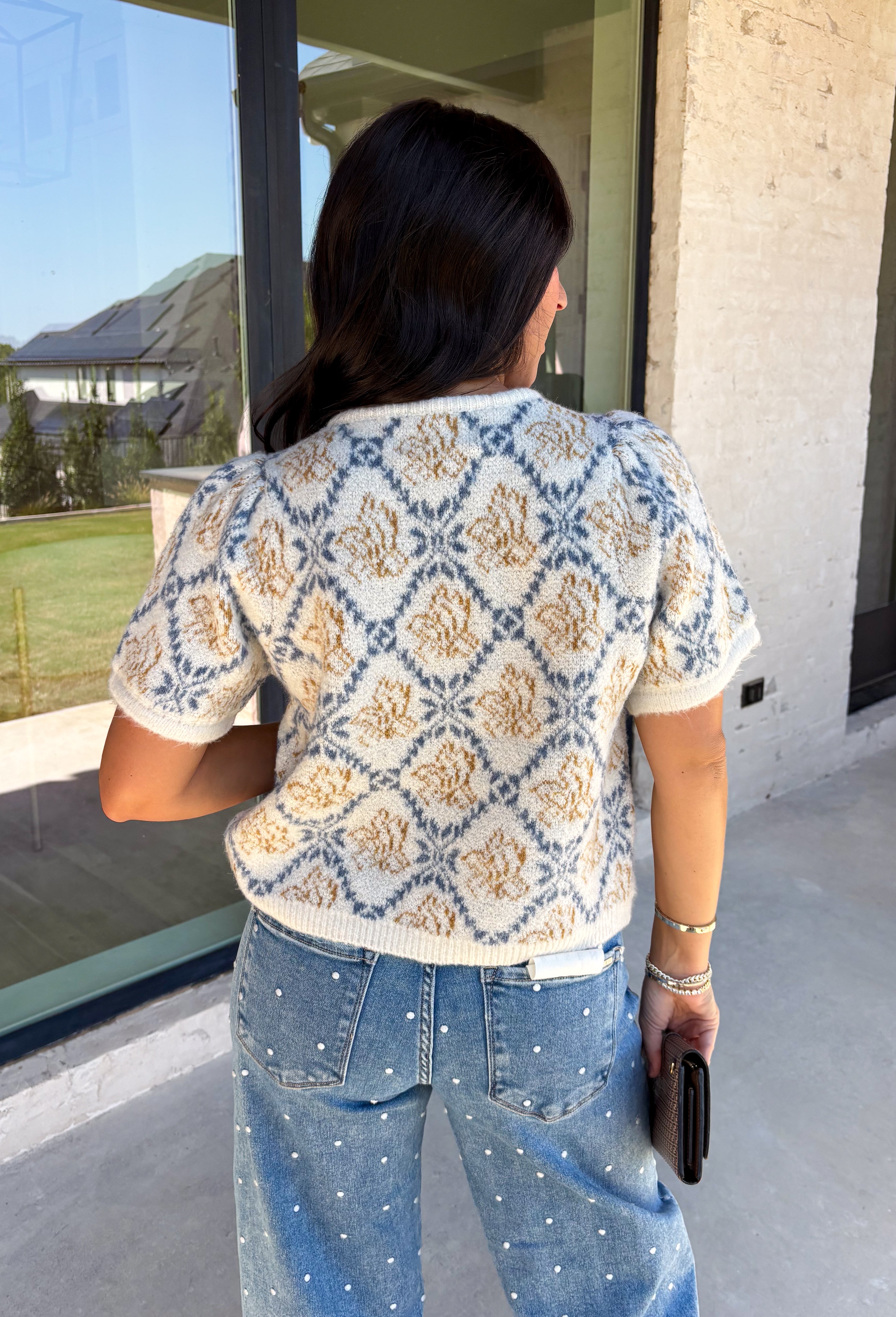 Give your fall layers a vintage-inspired update with this soft short sleeve cardigan from & Merci. The mix of muted denim blue, warm camel, and ivory creates a cozy, lived-in color palette that feels right at home with your favorite autumn outfits. A button-down front makes it easy to wear closed as a top or open over a simple tank for a layered look. Soft and comfortable with just the right amount of stretch, this printed cardigan is an easy statement piece.