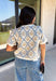 Give your fall layers a vintage-inspired update with this soft short sleeve cardigan from & Merci. The mix of muted denim blue, warm camel, and ivory creates a cozy, lived-in color palette that feels right at home with your favorite autumn outfits. A button-down front makes it easy to wear closed as a top or open over a simple tank for a layered look. Soft and comfortable with just the right amount of stretch, this printed cardigan is an easy statement piece.