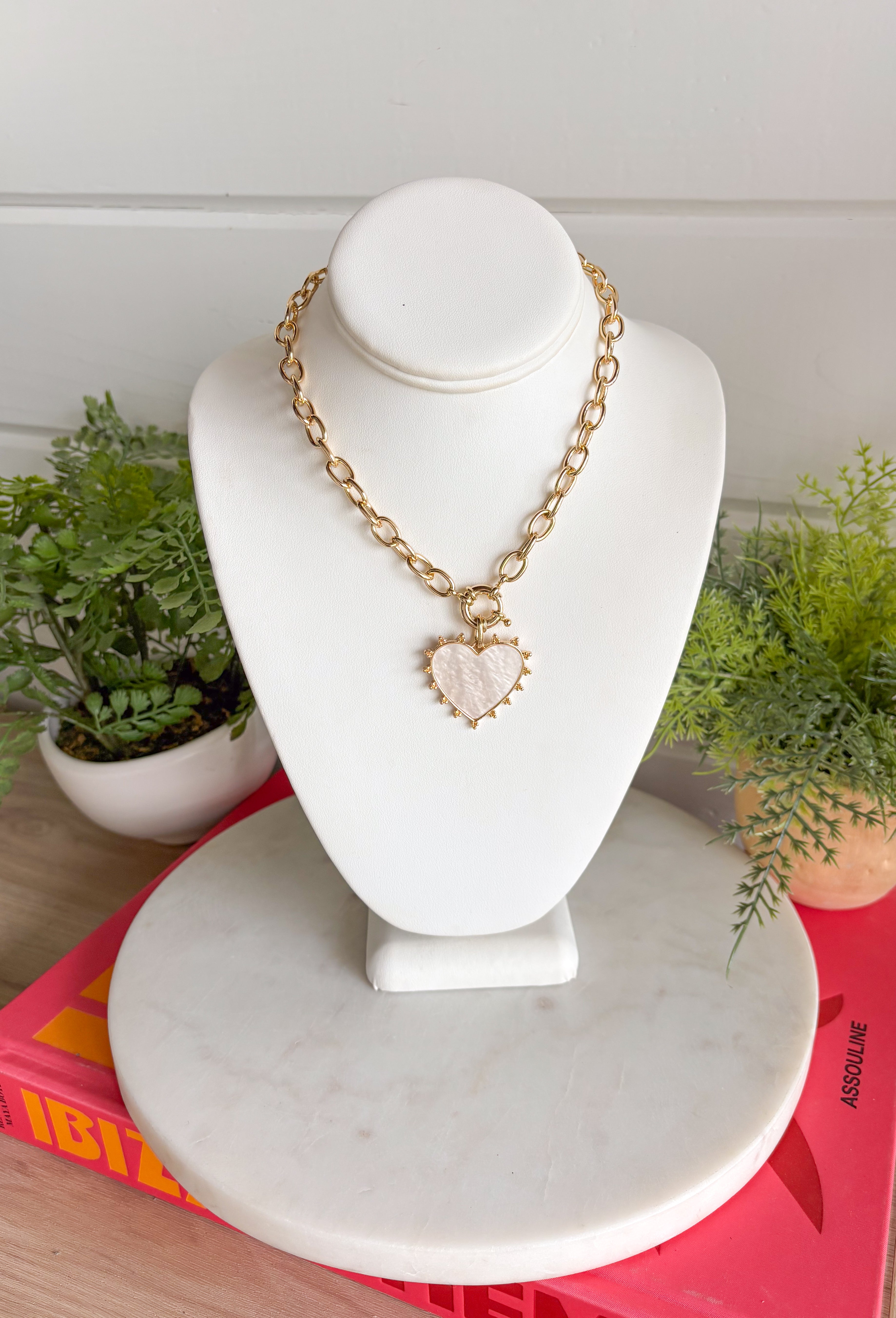 Elegant with a soft, feminine glow! This gold open chain link necklace features a beautiful mother of pearl heart pendant outlined in polished gold for a timeless look. The natural shimmer of the pearl gives the piece a delicate, luminous finish that feels both classic and modern. The open link chain adds a stylish touch while keeping the design easy to wear and versatile. 