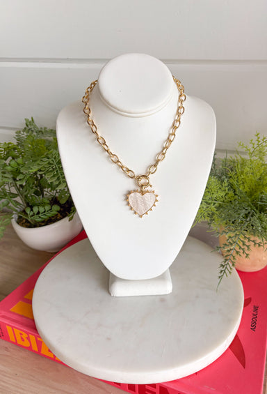 Elegant with a soft, feminine glow! This gold open chain link necklace features a beautiful mother of pearl heart pendant outlined in polished gold for a timeless look. The natural shimmer of the pearl gives the piece a delicate, luminous finish that feels both classic and modern. The open link chain adds a stylish touch while keeping the design easy to wear and versatile. 