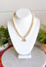 Elegant, timeless, and effortlessly versatile, this ivory beaded necklace is the perfect accessory to elevate any outfit. Featuring beautiful ivory beads, this classic piece is accented with a dazzling crystal rhinestone charm that adds just the right amount of shimmer. Whether you're dressing up a cozy sweater, styling your favorite blouse, or adding a polished finishing touch to a special occasion look, this necklace is one you'll reach for season after season.