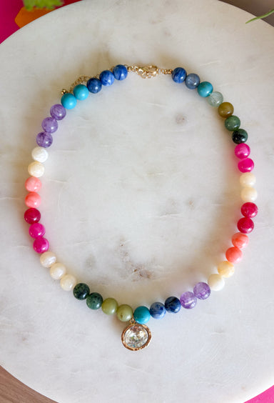 Bright, playful, and full of personality, this colorful beaded necklace is the perfect finishing touch for any outfit. Featuring vibrant multicolored beads, this cheerful accessory is accented with a dazzling crystal rhinestone charm that catches the light beautifully. Whether you wear it on its own as a statement piece or layer it with your favorite gold chains, this necklace adds the perfect pop of color and shine to every look.