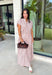 Add a fresh twist to your fall wardrobe with this light pink striped top from Day + Moon. The warm brown stripe print gives the soft pink color an autumn-ready feel, while the front zipper adds a fun, modern detail. Elastic at the hem and sleeves creates a comfortable shape that's easy to wear throughout the day. Pair it with the matching midi skirt for a coordinated two-piece set, or style it on its own with your favorite denim or chocolate brown bottoms.