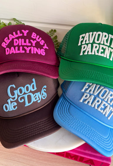 This burgundy trucker hat features “Really Busy Dilly Dallying” in the cutest hot pink bubble font, giving it that fun, carefree personality we love. The bold color combo makes a statement while the classic mesh backing keeps it breathable and easy to wear. Toss it on for errands, ball games, coffee runs, or those days when you’re technically productive… just at your own pace.