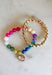 The easiest way to add a fun pop of color to your everyday look! This set of two pull-on bracelets is designed for effortless styling, featuring one colorful beaded bracelet with a sparkling crystal charm embellishment and one classic gold beaded bracelet. Wear them together for a perfectly layered look, or style each one on its own to complement any outfit. 