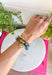 The easiest way to add a fun pop of color to your everyday look! This set of two pull-on bracelets is designed for effortless styling, featuring one colorful beaded bracelet with a sparkling crystal charm embellishment and one classic gold beaded bracelet. Wear them together for a perfectly layered look, or style each one on its own to complement any outfit. 