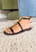 A timeless sandal with a polished finish! These black strappy sandals feature sleek straps accented with a statement gold hardware for the perfect hint of shine. An adjustable ankle strap provides a secure and comfortable fit, making them easy to wear all day. Whether you're pairing them with dresses, denim, or tailored pieces, these sandals are a go-to option that can easily be dressed up or down.