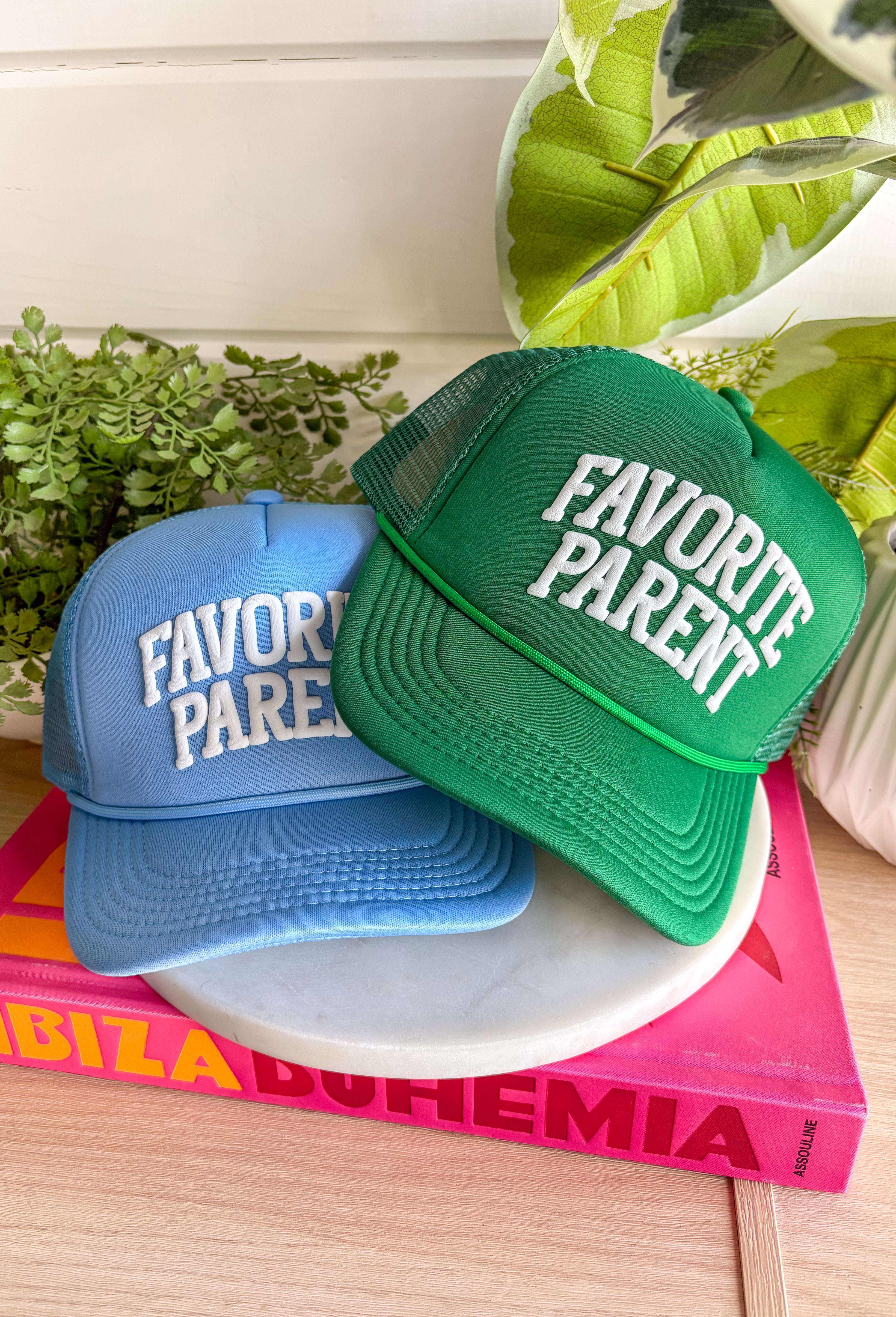 Claim the title loud and proud! This light blue trucker hat features “Favorite Parent” in bold white bubble letters for a playful, confident statement. It’s fun, lighthearted, and guaranteed to spark a few laughs at pickup line or the next family outing. The soft blue color keeps it fresh and easy to style, while the breathable mesh backing and adjustable fit make it comfortable for everyday wear.