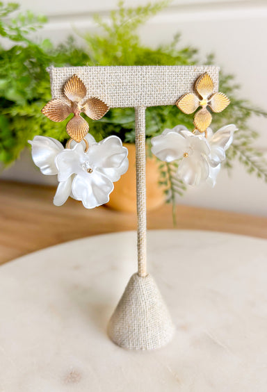 Designed with three stacked cream flowers and dainty bead detailing at the center of each, they’re the perfect touch of texture. Lightweight and effortless, they’re ready to elevate any outfit—whether you’re dressing up for brunch or keeping it casual in denim.&nbsp;