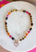 Rich autumn tones and elegant details come together in this stunning statement necklace. Featuring shades of brown with beautiful pops of pink and rust, this beaded design is accented with delicate gold spacer beads that add the perfect touch of shine. The mother-of-pearl heart pendant framed in gold creates a timeless focal point, while the toggle detail and lobster clasp complete this effortlessly elevated accessory. It's the perfect finishing touch for all your favorite fall looks.