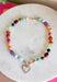 Rich autumn tones and elegant details come together in this stunning statement necklace. Featuring shades of brown with beautiful pops of pink, teal, green, purple, and rust, this beaded design is accented with delicate gold spacer beads that add the perfect touch of shine. The mother-of-pearl heart pendant framed in gold creates a timeless focal point, while the toggle detail and lobster clasp complete this effortlessly elevated accessory. It's the perfect finishing touch for all your favorite fall looks.