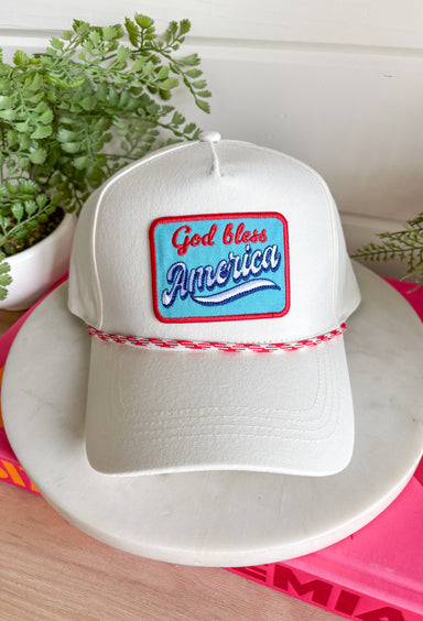 This white trucker hat with red and white trim is the perfect finishing touch for all your summer celebrations! The bold blue patch outlined in red with “God Bless America” adds that classic patriotic feel, while the subtle trim detail along the bill gives it a fun, standout edge. Designed with a adjustable fit, it’s made for long days in the sun—from 4th of July festivities to lake days and backyard BBQs. It’s an easy grab-and-go accessory that instantly pulls your look together. 