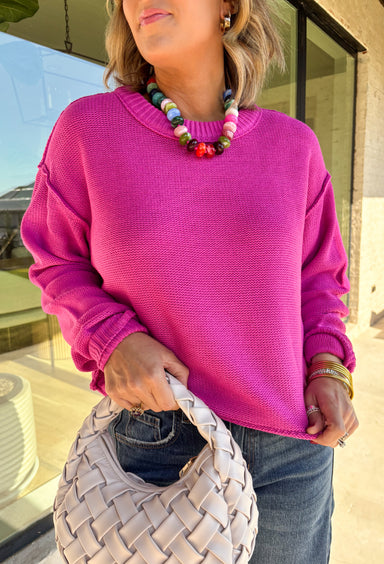 Nothing says cozy season like a classic fuchsia sweater, and this timeless knit from Double Zero is one you'll reach for again and again. Designed in a fuchsia hue, this effortlessly versatile sweater features exposed seam detailing that adds a modern touch to its classic silhouette. Ribbed trim at the neckline and cuffs provides a polished finish, while the soft knit construction keeps you warm and comfortable all day long.