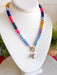 This colorful beaded necklace is the perfect accessory for adding a playful pop to your summer style! Featuring vibrant beads, a chic gold toggle clasp, and a pearl pendant charm, it combines trendy details with a timeless touch. The mix of color and pearl accents creates a fun, elevated look that's easy to wear with everything from casual tanks to breezy dresses. Whether you're heading on vacation, brunch with friends, or simply brightening up an everyday outfit, this necklace is sure to become a favorite.