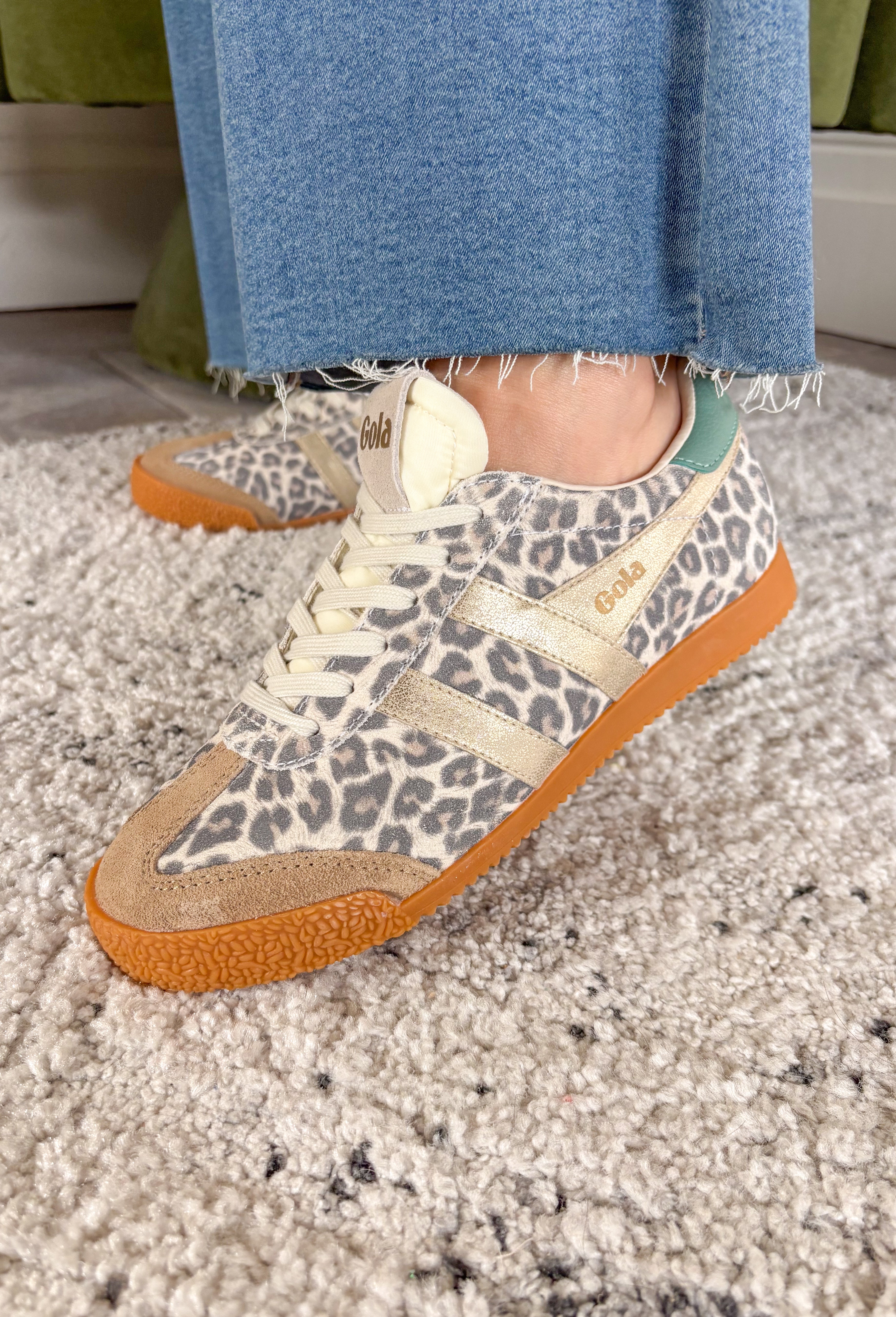 A fan favorite with a bold new twist! The Gola Elan Safari sneaker brings a fresh update to a classic silhouette with its all-over snow leopard print suede. The rich mix of caramel, gold, and green tones adds warmth and dimension, making this pair a standout while still feeling easy to style. Blending heritage-inspired design with a modern edge, this sneaker delivers both comfort and personality. 